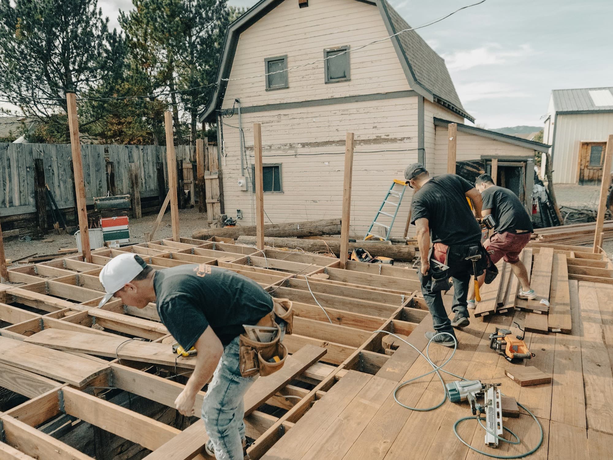 Our crew framing and laying deck boards for a new backyard deck